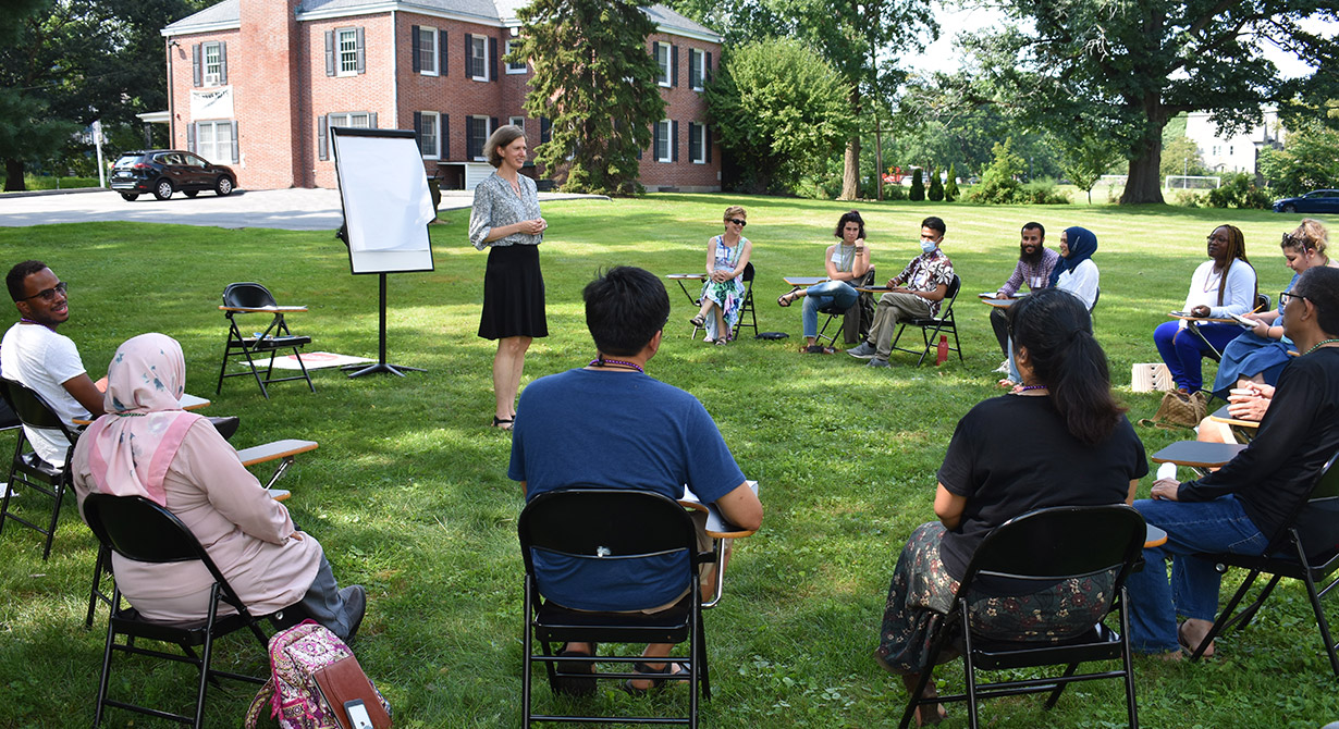 =students having class out on the campus lawn