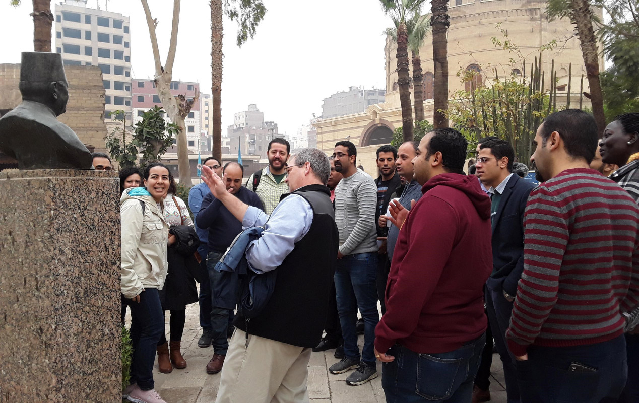 =Students observing a sculpture