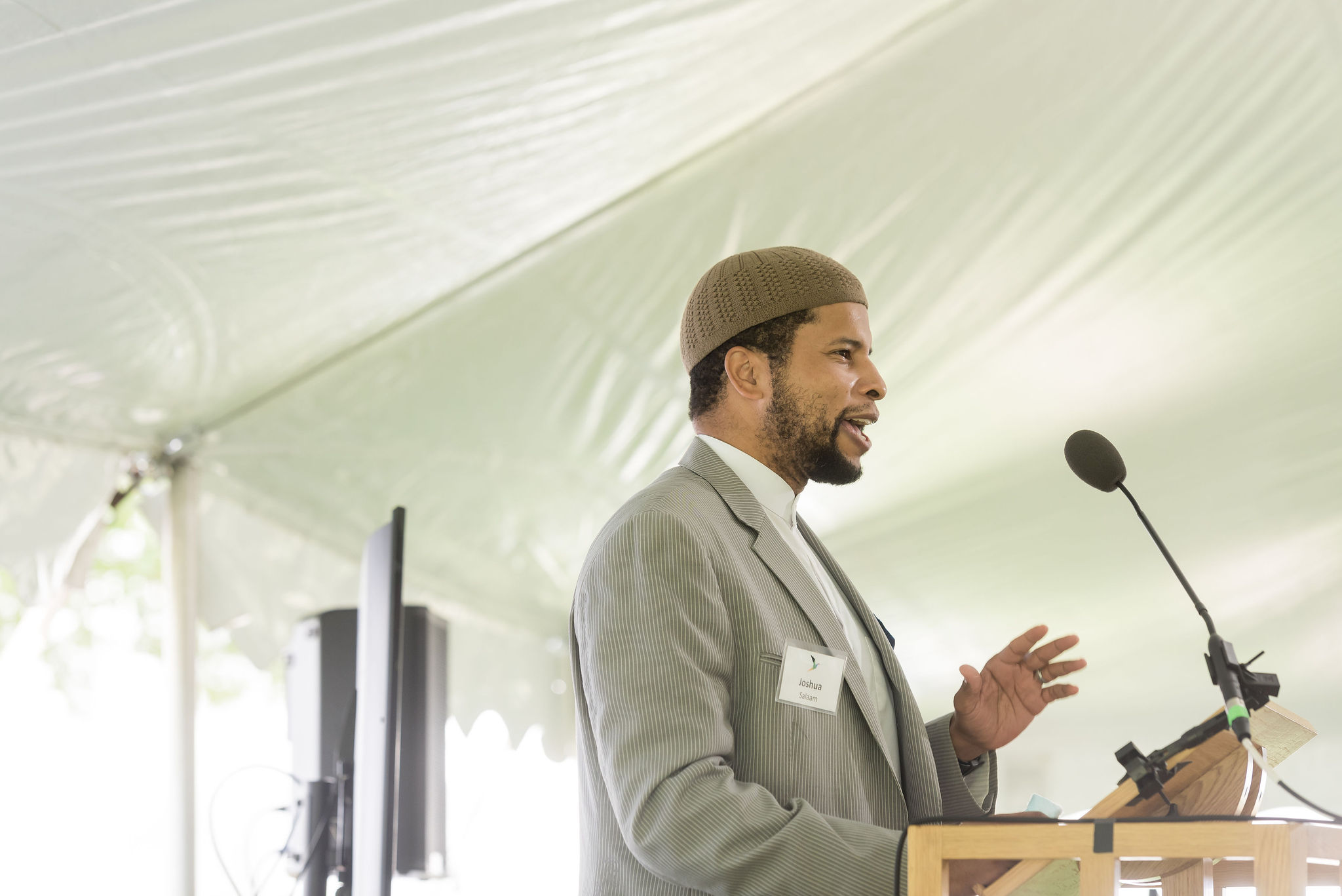 Joshua Salaam speaking at podium