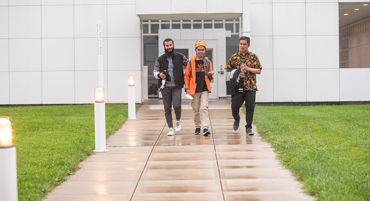 =students walking out of main building on hartford international campus