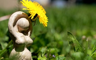 small statue of woman in grass