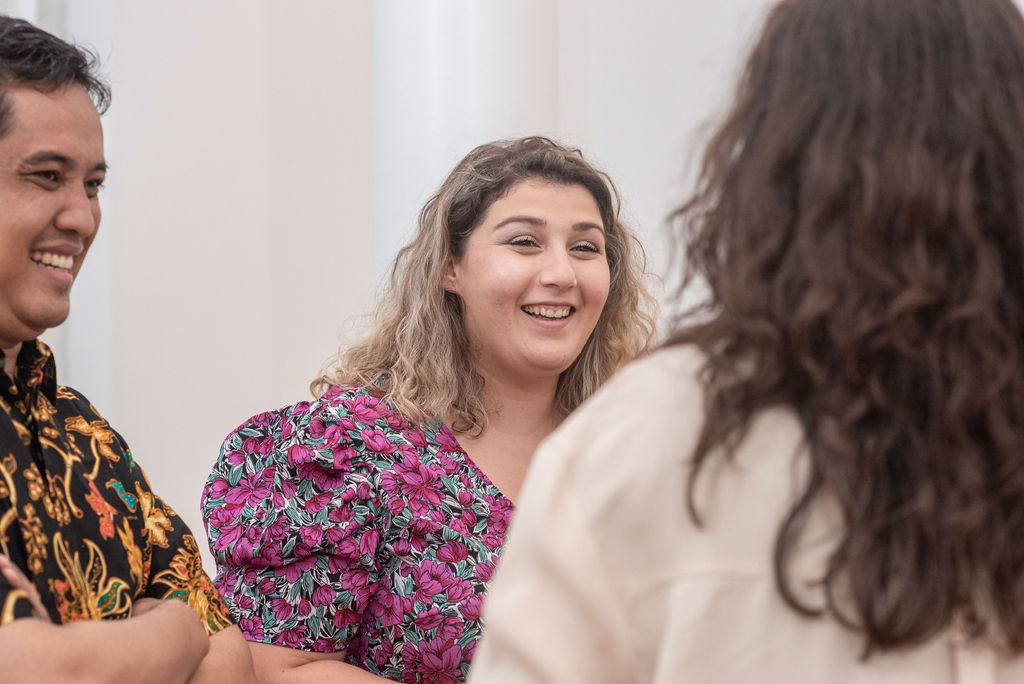 =Group of three smiling students chatting