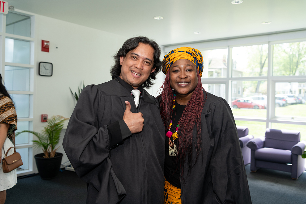 Two graduates smiling