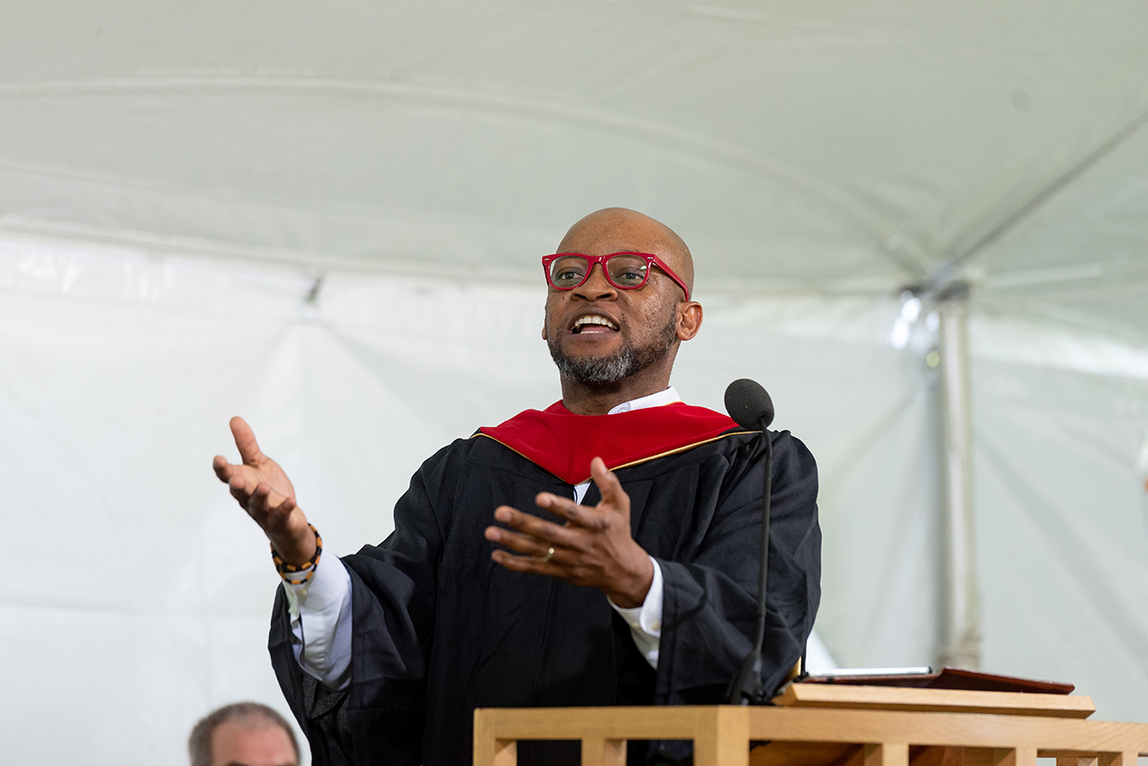 Man wearing glasses at podium