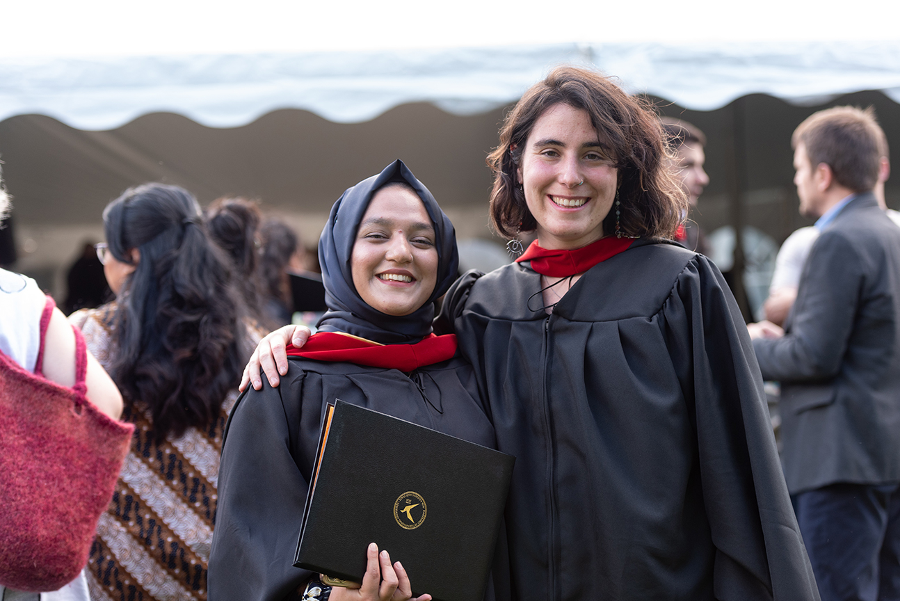 Graduate in hijab next to another graduate