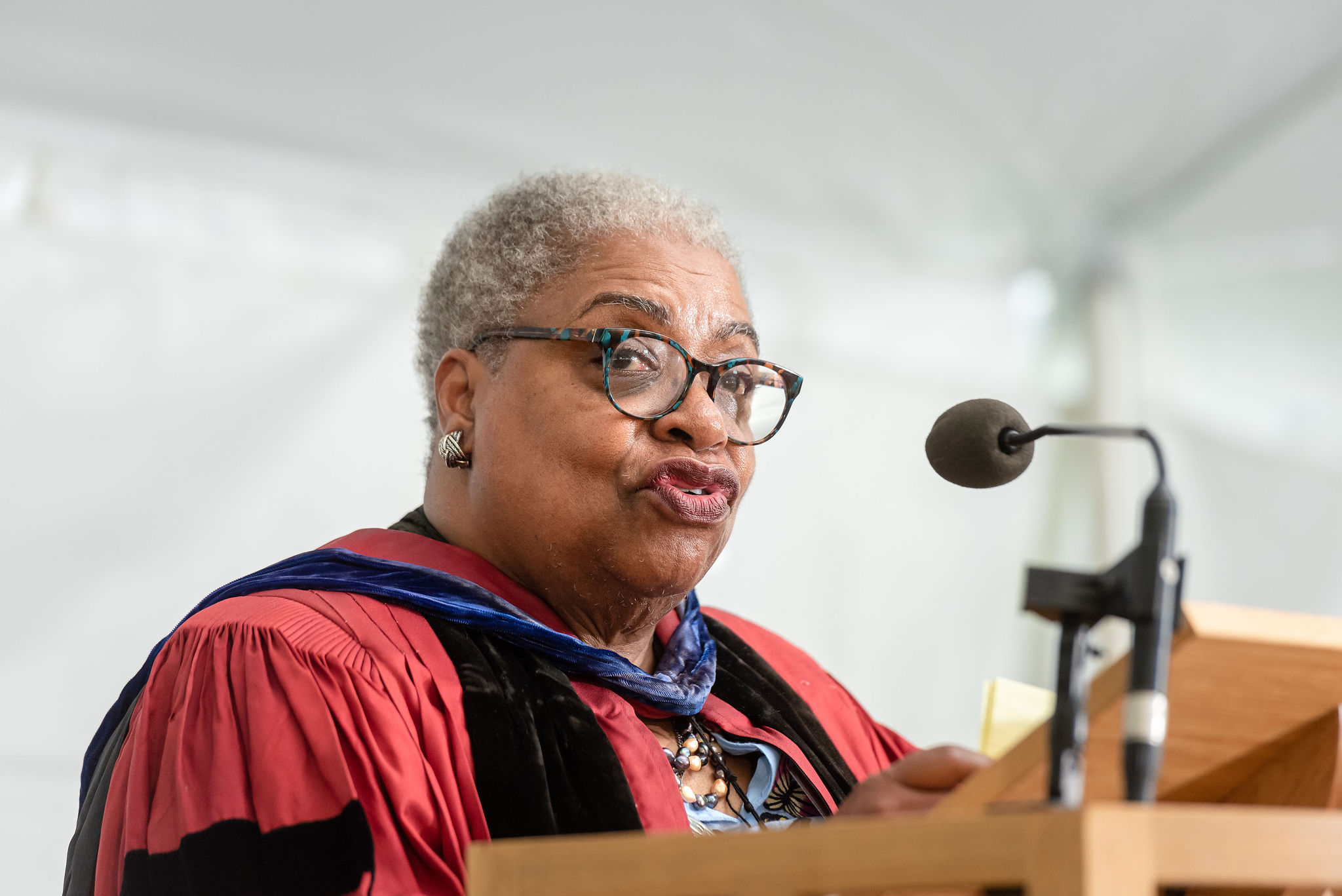 A woman speaker with glasses