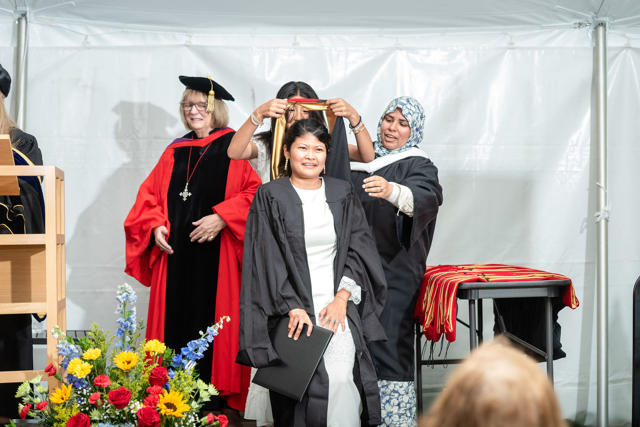 Woman being hooded at graduation