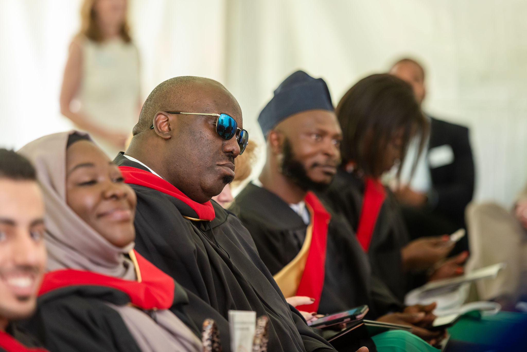 Row of graduates listening