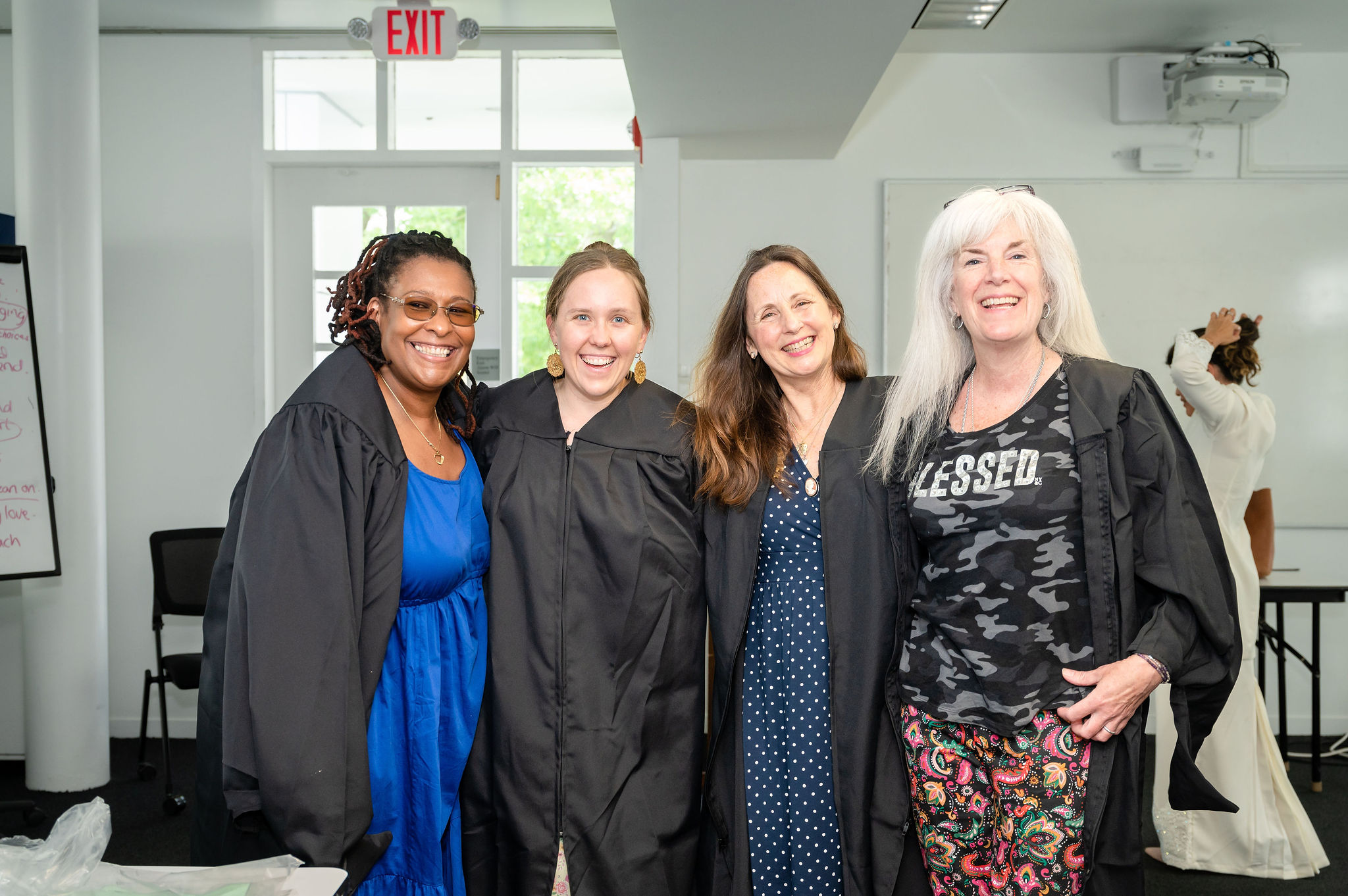 Four graduates in robing room