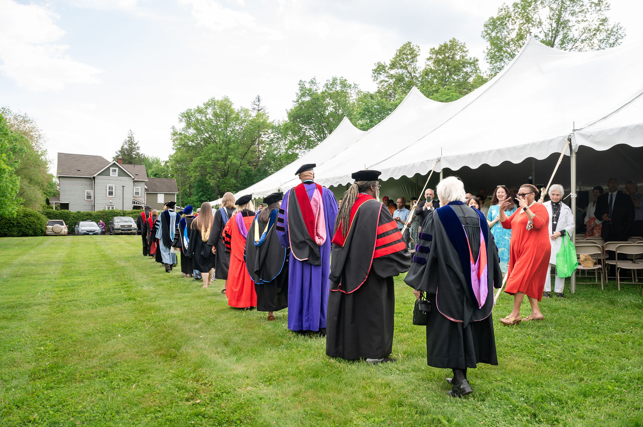 Graduates processing outside tent