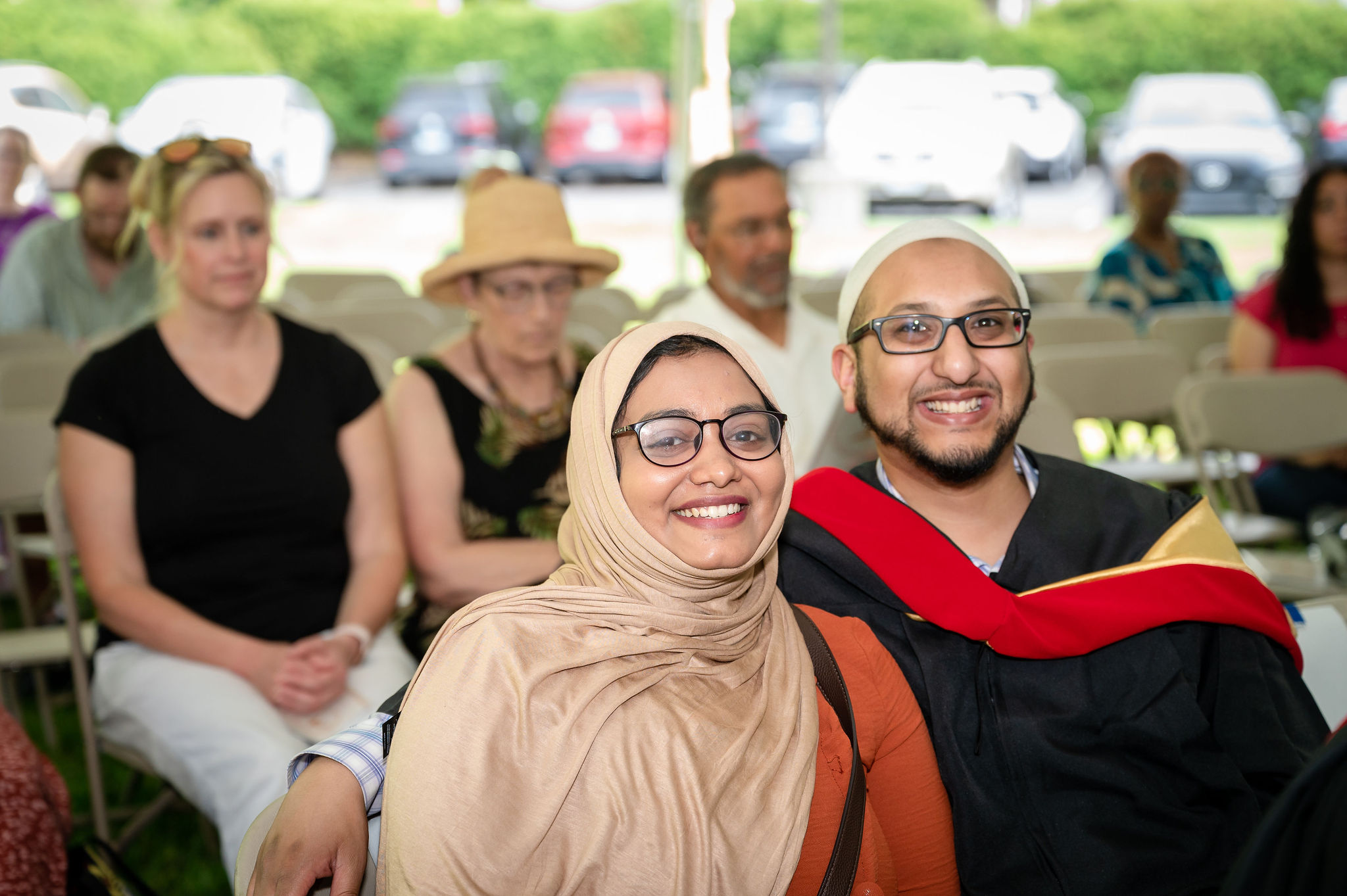 Woman in hijab next to graduate