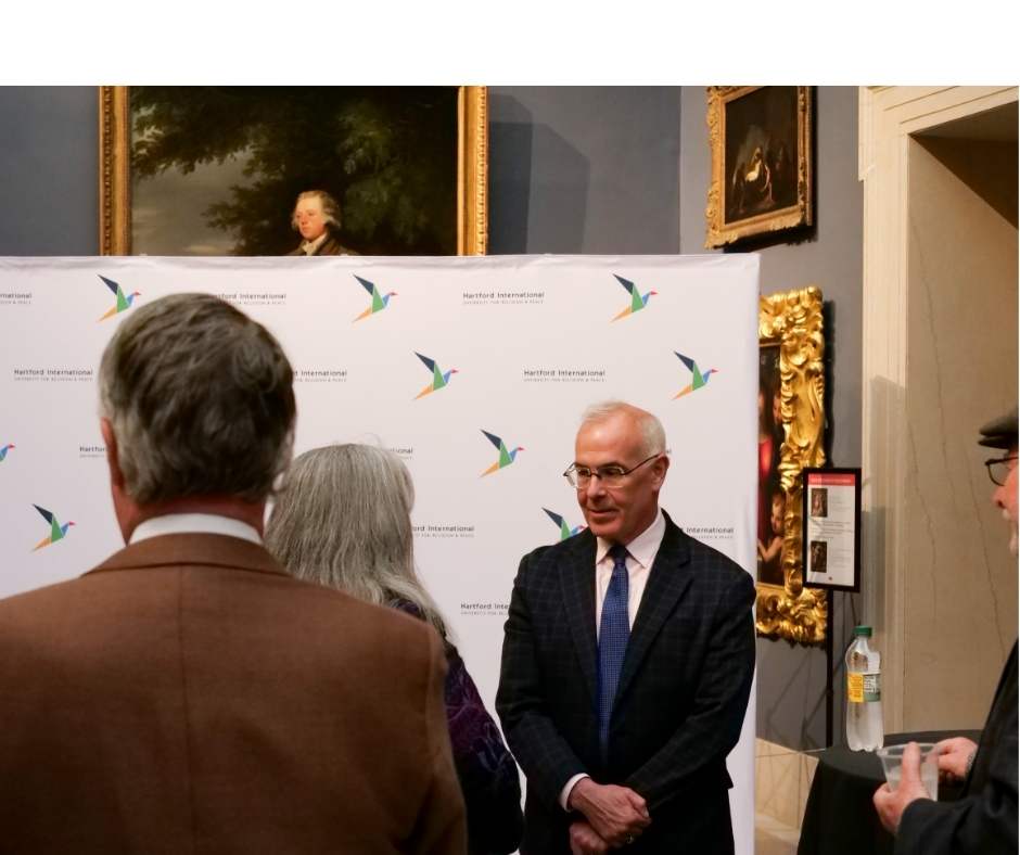 David Brooks talking to a woman at reception