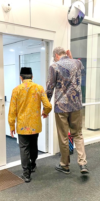 Imam and Joel exiting door