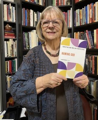 Lucinda Mosher holding her book