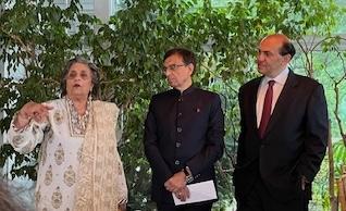 One woman and two men speaking